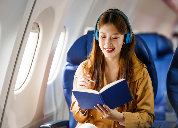 Woman reading a book on a plane